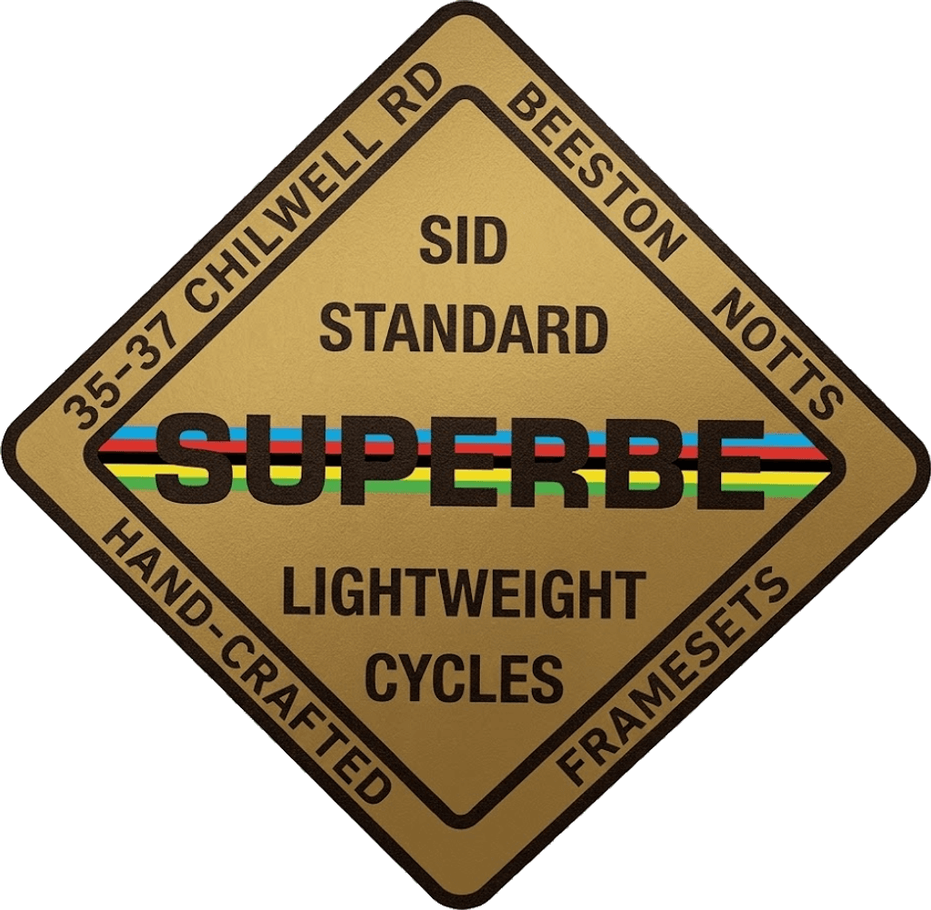 A gold diamond head badge with a dark brown border, lettered SID STANDARD, SUPERBE over rainbow bands, LIGHTWEIGHT CYCLES, and around the four edges 35-37 CHILWELL RD, BEESTON NOTTS, HAND-CRAFTED, FRAMESETS.