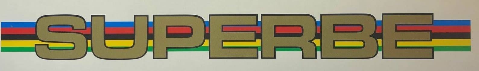 The word SUPERBE in heavy gold capitals with a black keyline, set over five horizontal bands: blue, red, black, yellow and green.